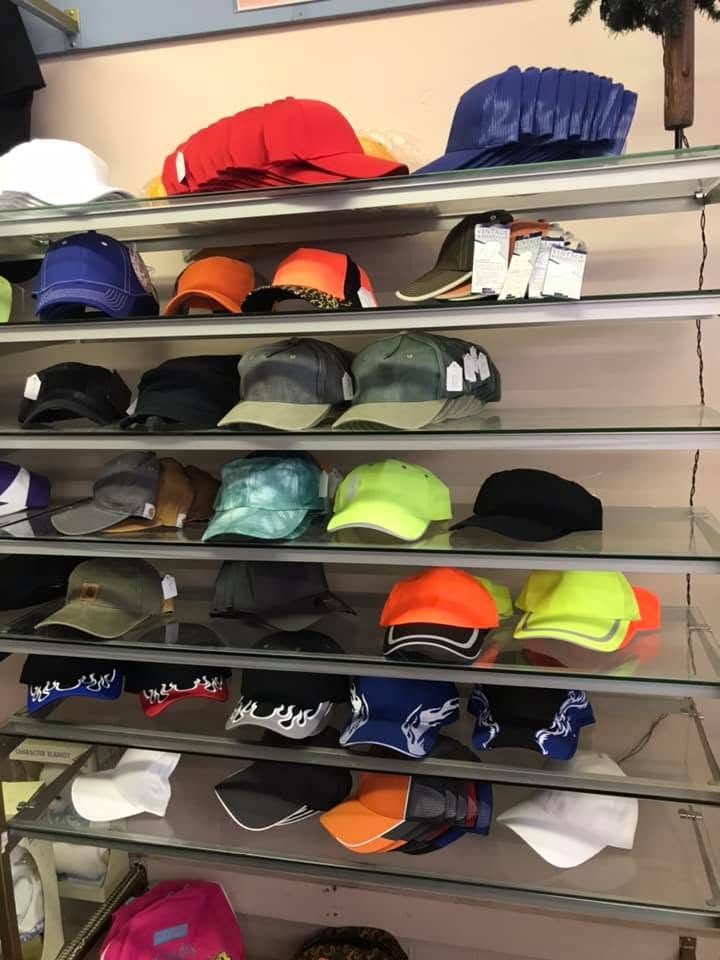 Store shelves stocked with rows of caps in many colors