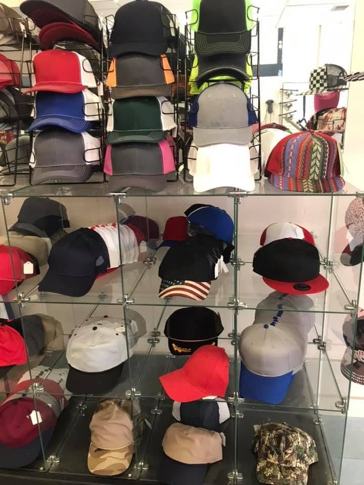 Wall of caps and hats in many styles and colors, including camo
